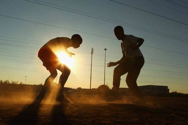 Barefooted and Dribbling-In The Dust and At Dusk.. Soccer Is A Way Of Life Of The Poor In South Africa