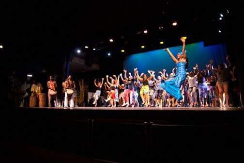 Sis. Omelika leads audience participation at the end of her semester Final Performance with her students where she raises money for the 'Mozel Spriggs Scholarship Fund'.