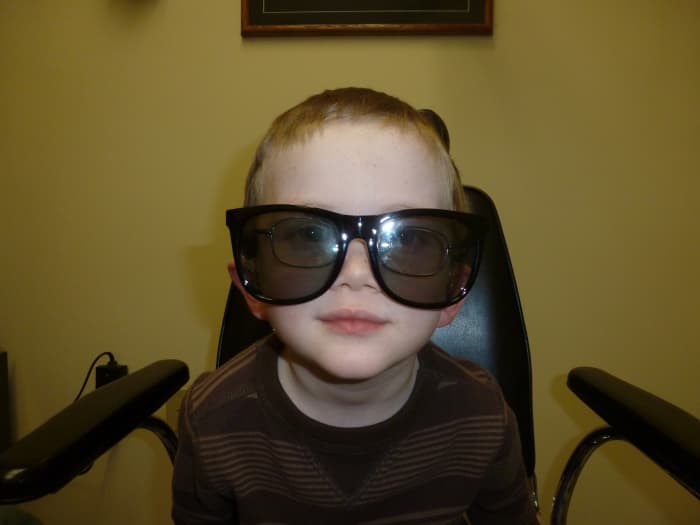 Poorly fitting glasses will not serve a child well. This picture is of my son wearing a pair of stereoscopic glasses to determine if he can see in three dimensions (he has amblyopia, and cannot perceive depth).
