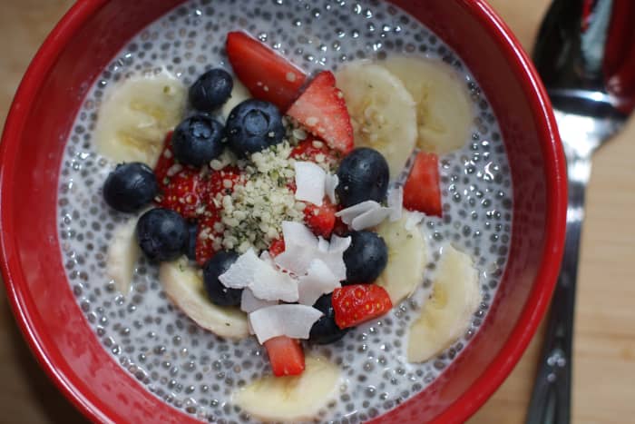 Chia seeds pudding with almond milk, bananas, strawberries, blueberries, coconut, hemp seeds.