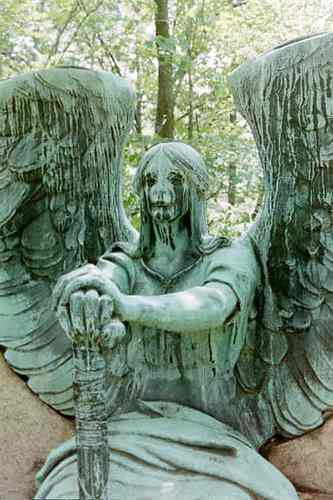The sculpture is named "Angel of Death Victorious". He sits at the grave with an overturned Torch....Wings spread....Guardian of the Dead