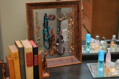 A beautiful accent - unpainted and without any fabric backing, I made hooks from paper clips to hang necklaces on.