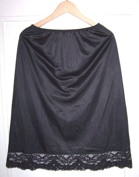 A black Vassarette vintage half slip with lace trim at the hem from the photos of Geneviève on Wikipedia