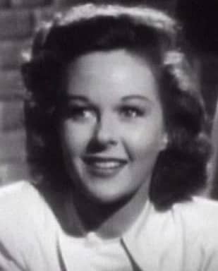 Susan Hayward's roundish face looks longer and squarer because of the squared, geometric style that draws the eye down the entire length of her face.