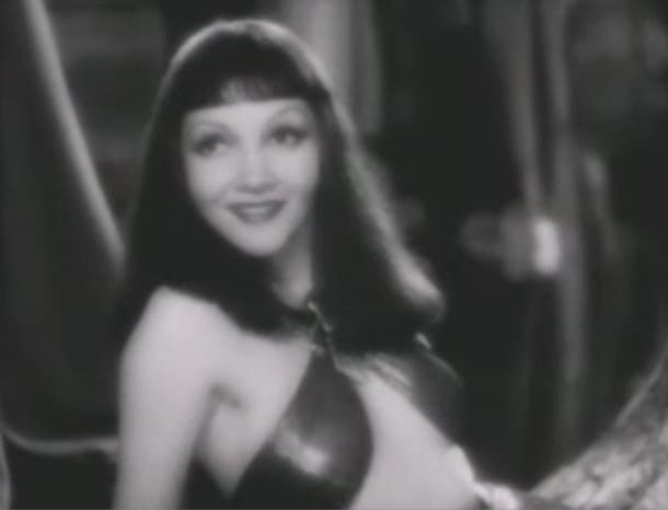 Claudette Colbert's face looks so nice and long with this long hair. The bangs cropped midway down her forehead give the impression of a long forehead. But hold on...