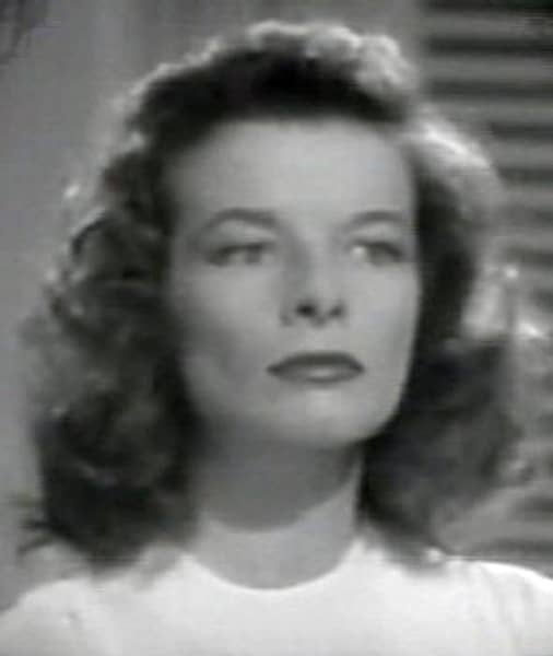 Katharine Hepburn's face still looks square in The Philadelphia Story, but without the bangs, it appears much less squashed. Her curls round out and soften the top of her head and the angles of her face, ending prettily below the neck.
