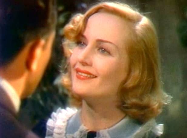 Another rounding off-center part. Carole Lombard's square jaw was minimized as the stylized waves drew focus to her eyes and below the jawline.