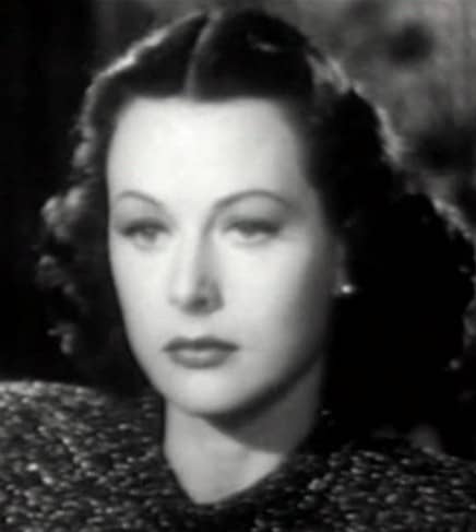 Hedy Lamarr wears a style that broadens at the base of her jaw, rounding out a long thin face shape and making it look more heart-shaped.