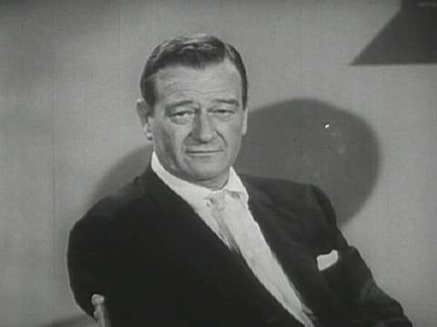 John Wayne's square-shaped face is perfectly acceptable in a guy--in fact, his boxy hairstyle made the most of it.