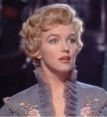 Marilyn again looking more round-faced because of the abundance of curls that stops above her jawline.