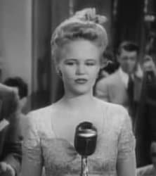 Peggy Lee's long face is emphasized here, but made more attractive by broadening the top of her head and drawing the eye to her broad forehead.