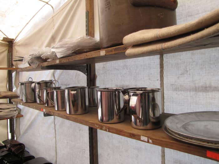 Shelves in a suttler's tent displaying plates and tin cups for soldiers. Photo taken at the March 2015 re-enactment of the Battle of Narcoosie Mill in St Cloud, Florida.