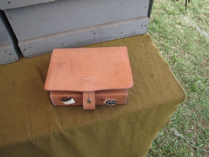 Civil War re-enactors can get handmade leather replicas to use. This one contained several tin lined compartments which I think would hold gunpowder or bullets.