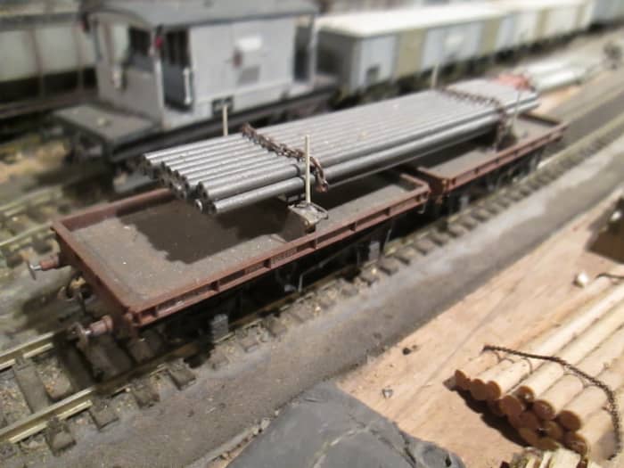 Parkside British Railways' Twin Bolster set, wagons linked by plastic bar. Plastic bolster posts replaced with shorn steel dressmaker's pins