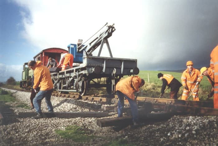A sleeper wagon-mounted grab crane for replacing and removing sleepers on the Embsay & Bolton Abbey Railway near Skipton, North Yorkshire