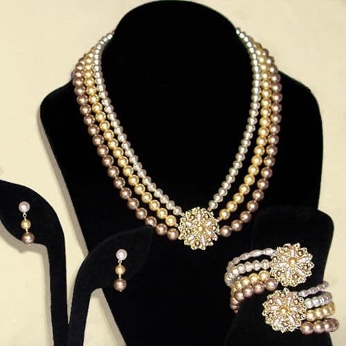 One-of-a-kind three-strand pearl necklace with brass filigree medallion, hand-embroidered with natural and Swarovski crystal pearls using 32 gauge brass wire, with matching pearl drop earrings. A custom commission for a beautiful bride in Scotland.
