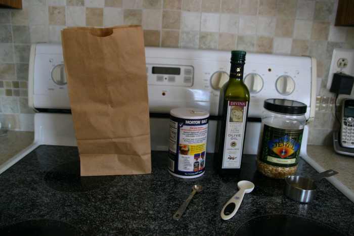 Salt, olive oil, and popcorn kernels are the only ingredients required to make homemade microwave popcorn.