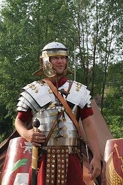 Lorica Segmentata on an re-enactor dressed as a Roman Legionnaire. note the different individual overlapping segments covering shoulders, chest, and stomach