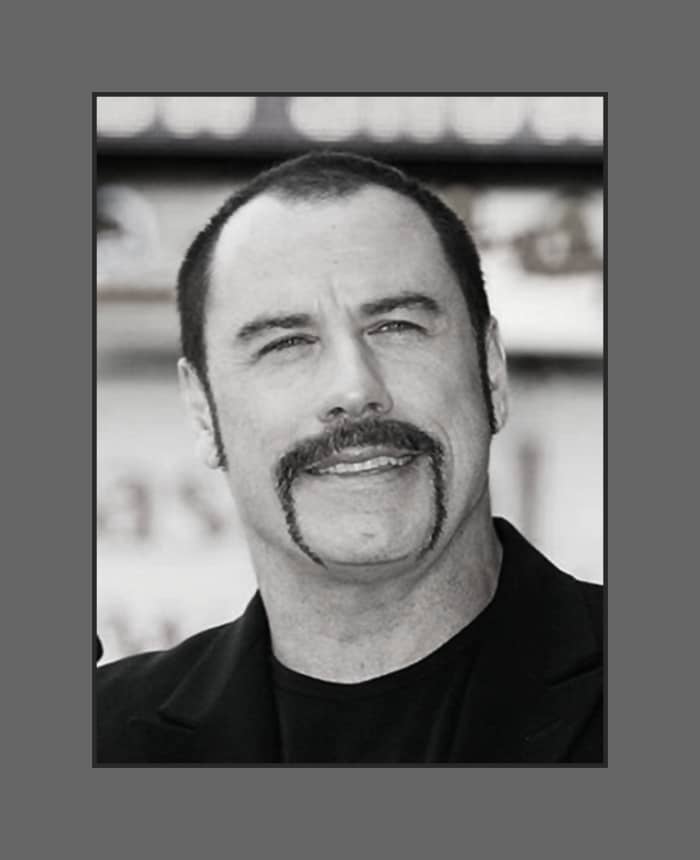 John Travolta has embraced his baldness and opted for buzz cut with a fu manchu mustache - 2013 Hairstyles for Men with Balding Thinning Hair Style Cuts Trends