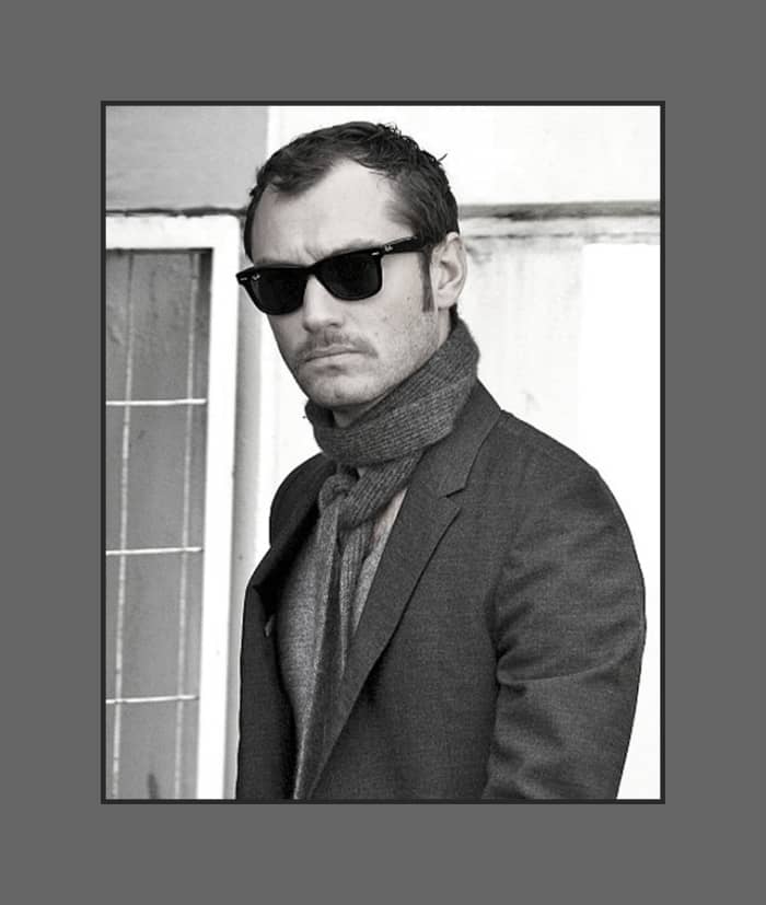Jude Law's hair is cut short layered all over with long thin sideburns, styled flat giving a bold look - 2013 Hairstyles for Men with Balding Thinning Hair Style Cuts Trends