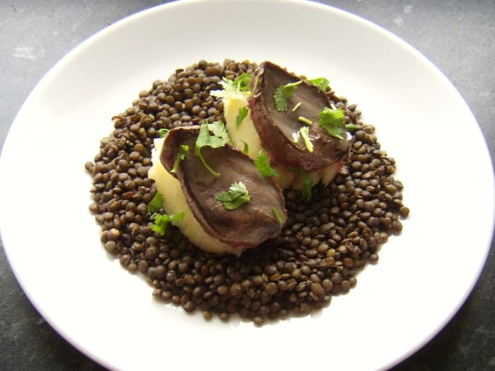 Pigeon is quickly pan seared and served on mounds of mashed potato and a bed of le Puy green lentils