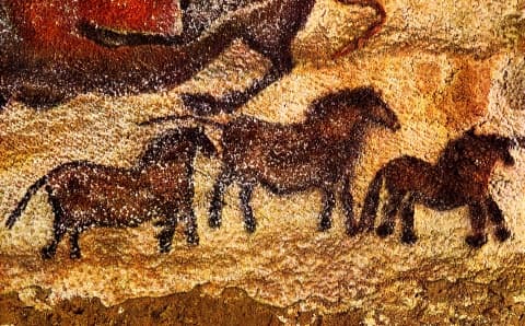Three tiny horses painted on one of the Lascaux cave walls in southwestern France. Horses are the most common animal to be found on these walls and these paintings are well over 16,000 years old.