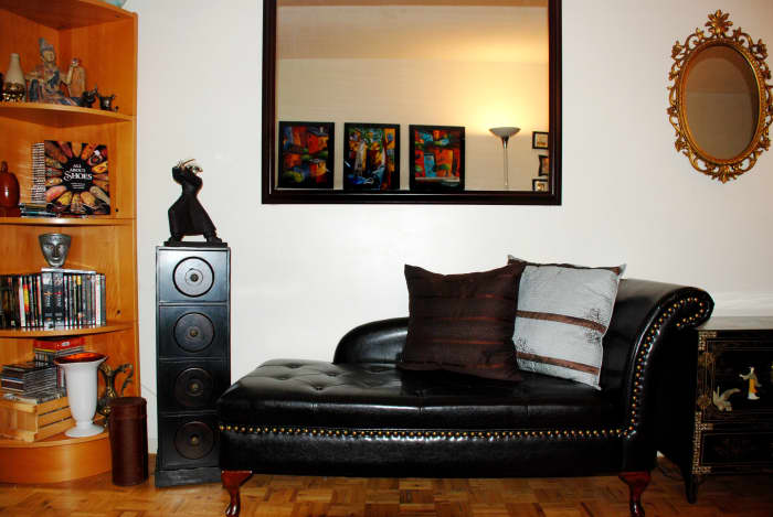 A rectangular mirror before expands the appearance of a small space; and it is presently hanging on a wall adjacent to the dining area.