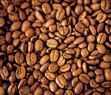 Close up of coffee beans on webmd article about health benefits of coffee. IT says "Coffee also contains minerals such as magnesium and chromium, which help the body use the hormone insulin, which controls blood sugar (glucose)."