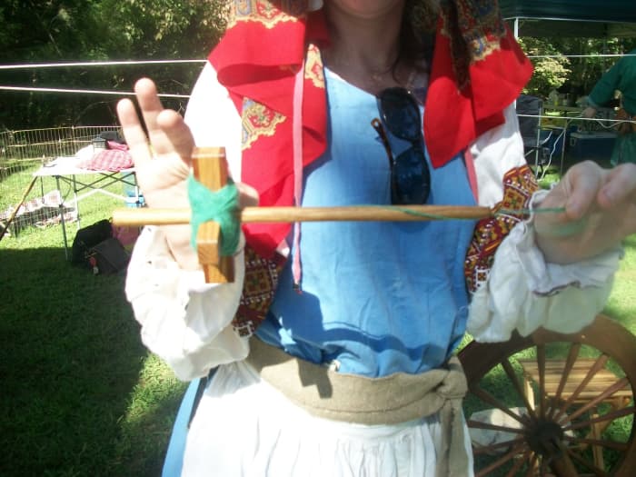 the woman showed me that when spinners had chores to do they could use this stick to spin their yarn and when they needed their hands to be free to do something they could put it in the inside of their dress, do what they had to do.
