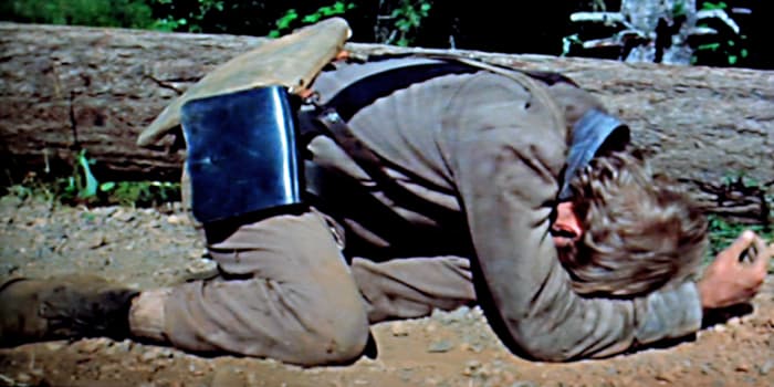A 16 year old soldier lies crumpled on the ground. But he has not been shot. Rather he is distraught after acting hastily and shooting someone by mistake. Such is war.