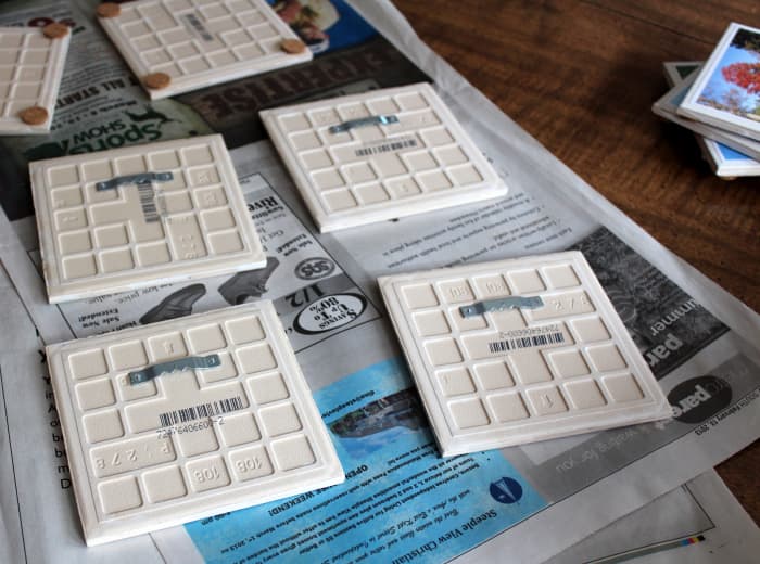 Attach sawtooth hangers to the back of ceramic tiles with E-6000 to hang them on the wall.