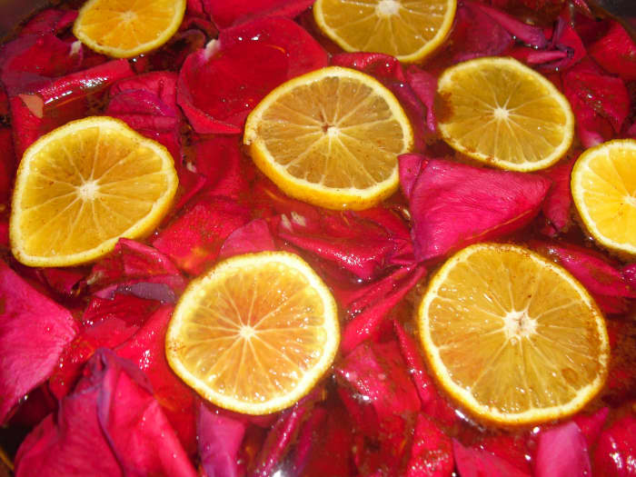 create your own fragrance blend of essential oils with petals and citrus slices in a room freshener.