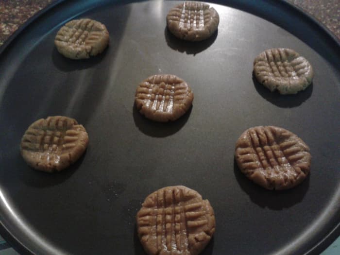 Press your cookies down with a fork to make a criss-cross pattern. This will help them bake evenly and quickly.