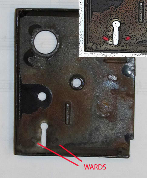 Interior side of lock case cover showing wards. Inset shows wards in red for visibility.