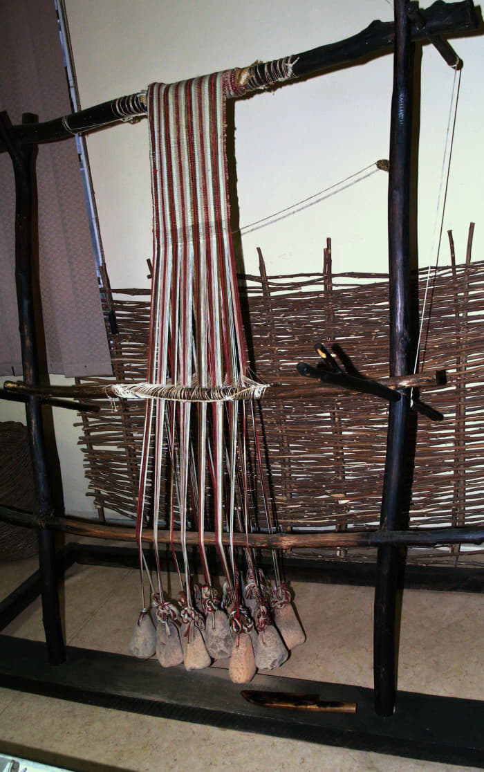 This reconstruction of a neolithic loom shows loom weights at the bottom of the apparatus. (At the National Museum of Textile Industry, Sliven, Bulgaria)