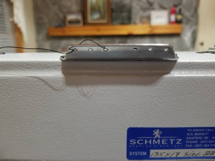 "...lead the thread from back to front through the lower guide hole in pin 1 on top of the machine arm, then again from right to left through the upper guide hole in this pin."
