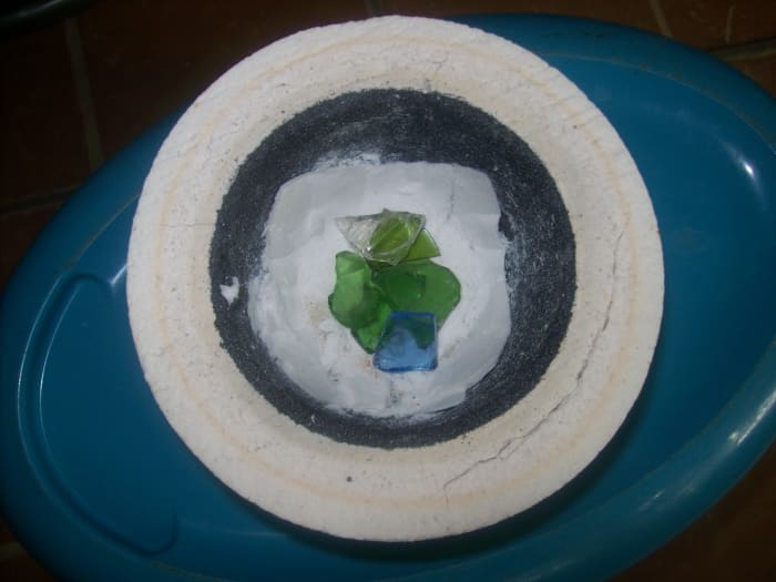 Six or seven small pieces of glass can give a nice puddle of fused glass. Pile them up a bit.