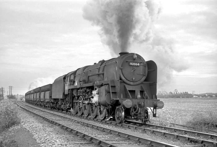 British Railways 9F 2-10-0 with train of 56t ironstone hoppers at Pelton between Tyne Dock and Consett - the class was fitted with air pumps to operate the doors on the 56 ton iron ore wagons pictured above