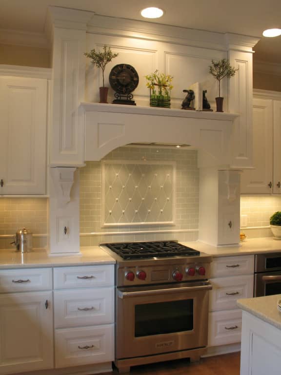 Old World kitchen design with standard tiles installed diagonally with accent deails makes this kitchen backslash customized and reminiscent of the Victorian era