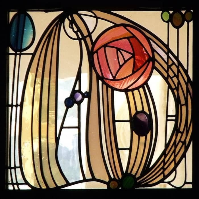 Stained glass window from The Hill House, Glasgow by Charles Rennie Mackintosh, featuring his iconic "Mackintosh Rose."