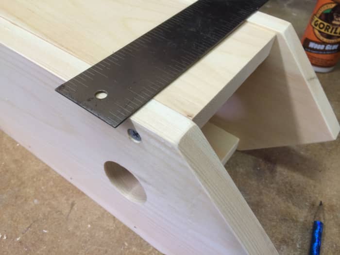 Lay out the pivot point for the door. The two screws are positioned exactly opposite from each other.