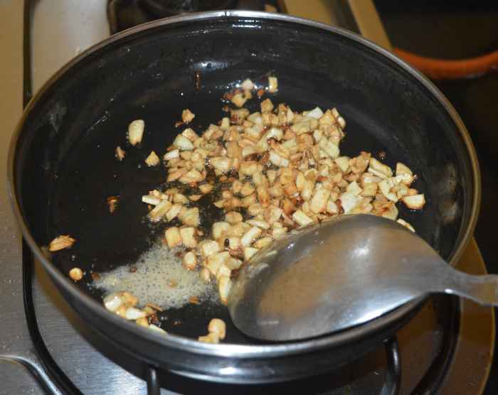 Add hing powder. Mix well. Turn off the heat.