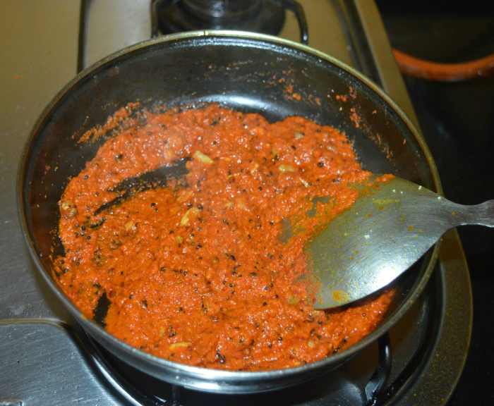 Continue to saute over low heat until the mixture becomes semi-solid and greasy (4 to 5 minutes).