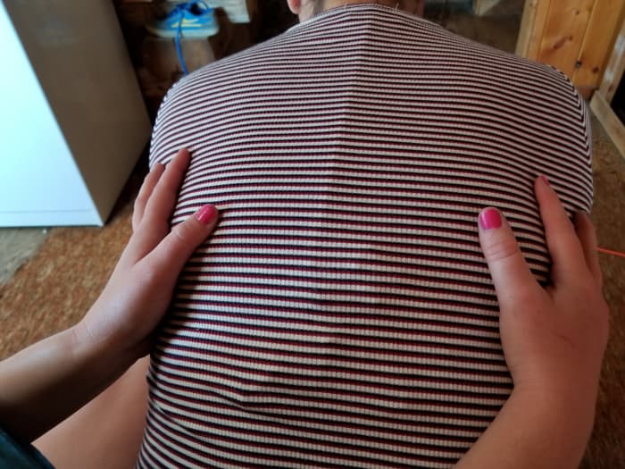 Feel for expansion in the back upon inhalation. Place yourself in a sitting position, leaning slightly forward with forearms resting on the thighs.