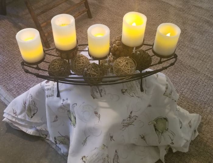 This candelabra helps create ambiance for garage dining. The base is a simple crate covered with a piece of fabric.