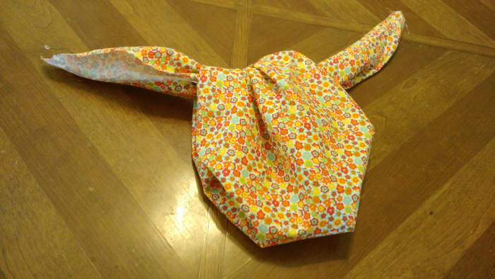 Option Two for Finishing the Bag: Tie the loose corners in a knot and pull it down as far as you can. Then tie the two loose ends in a knot, finishing the bag t