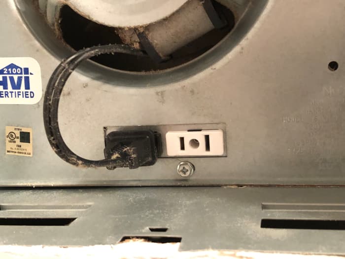 This unit's fan motor plugs into one electrical receptacle and its light plugs into the other.
