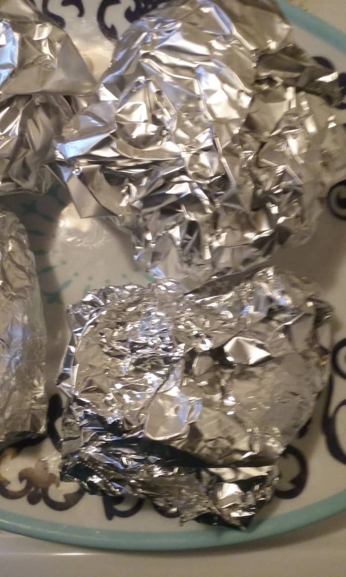 Wrapping the prepared burgers in foil helps to keep the juicy and delicious burgers from drying out.