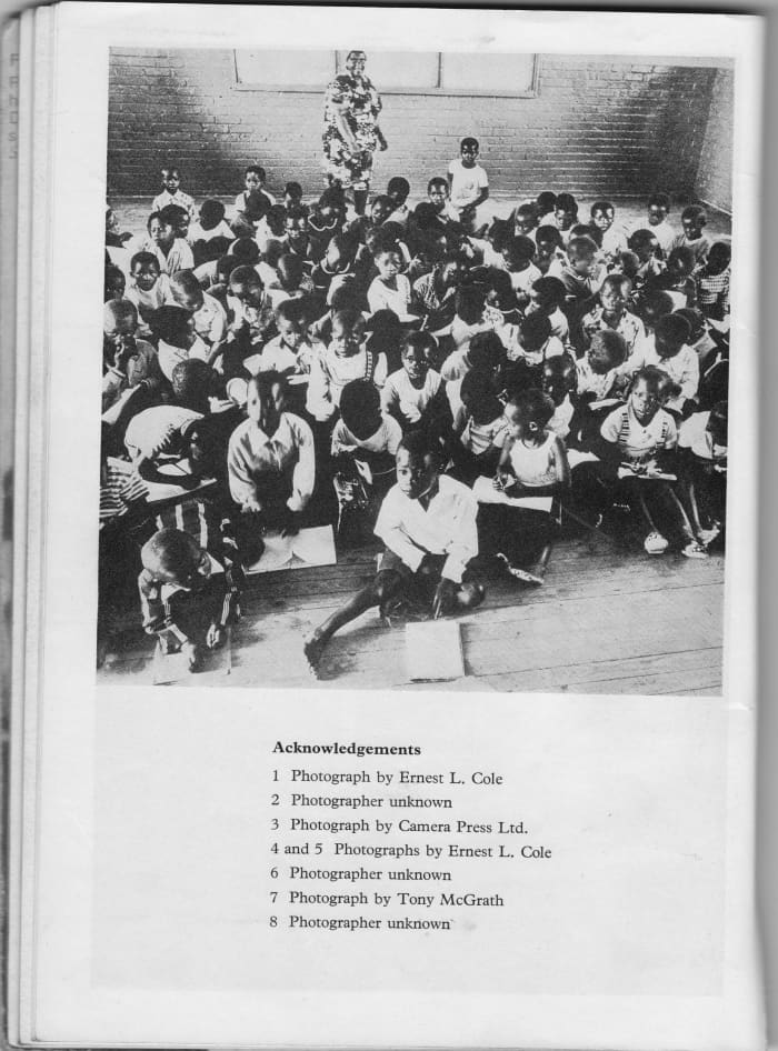 A really full class with no desks and children writing on the floor or have their books on their legs, or simply holding the book up and writing. At the same time, teachers were very strict about calligraphy. Photo # 8, Photographer Unknown.