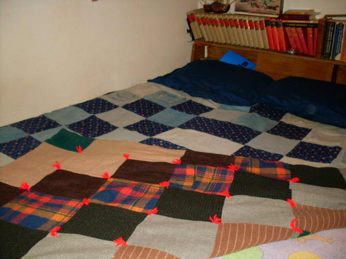 This queen-size quilt has two sides to display. The original top was sewn of wool squares, probably cut from old coats. I replaced the much-worn bottom with upcycled jean material and a fresh cotton print. This makes the quilt heavy, but warm.
